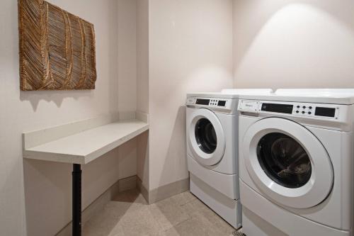 a laundry room with a washing machine and a counter at Tucson Marriott University Park in Tucson