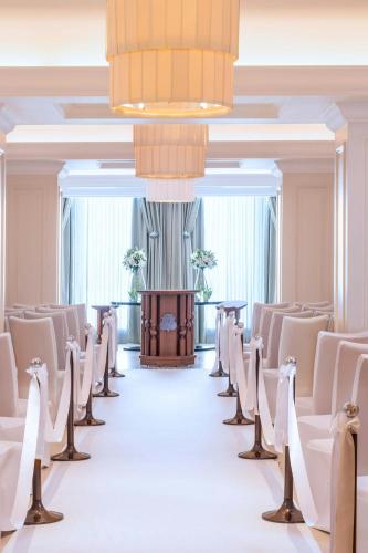 a row of chairs in a room with a chandelier at The St. Regis Osaka in Osaka