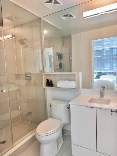 a bathroom with a toilet and a shower and a sink at Toronto Downtown Core Condo 2 BED 2 BATH in Toronto