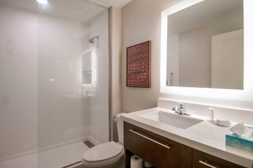 a bathroom with a sink and a toilet and a shower at TownePlace Suites by Marriott Vidalia Riverfront in Vidalia