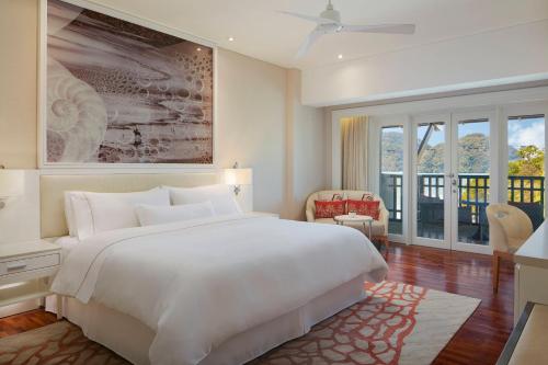 a bedroom with a large white bed and a window at The Westin Langkawi Resort & Spa in Kuah