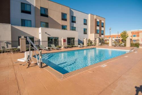 a large swimming pool in front of a building at TownePlace Suites by Marriott Vidalia Riverfront in Vidalia