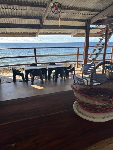 a patio with tables and chairs on the beach at Costa Cantagay in Jagna