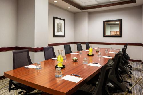 a conference room with a large wooden table and chairs at Sheraton West Des Moines in West Des Moines