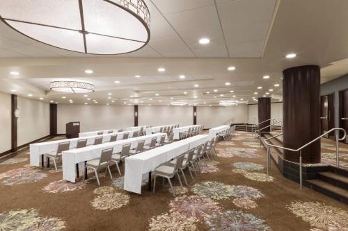 a room with rows of white tables and chairs at The Westin Seattle in Seattle