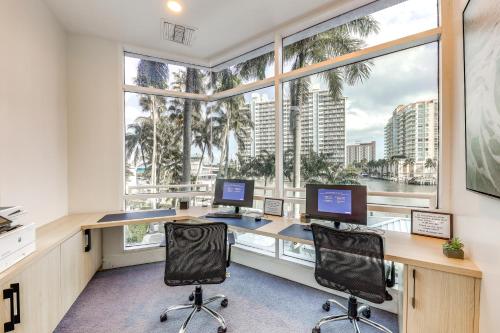an office with two computers and a large window at Modern Ft Lauderdale Condo about 7 Mi to Airport! in Fort Lauderdale