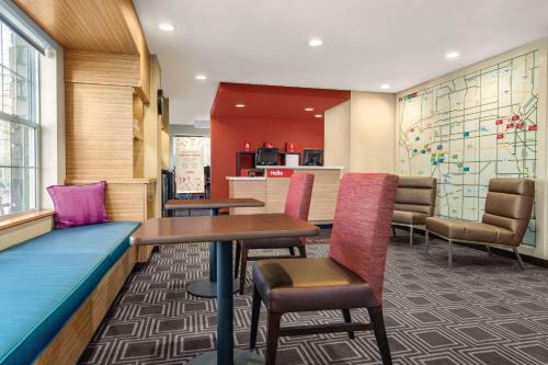 a waiting area at a hospital with tables and chairs at TownePlace Suites by Marriott Denver West Federal Center in Lakewood