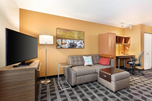 a living room with a couch and a flat screen tv at TownePlace Suites by Marriott Denver West Federal Center in Lakewood