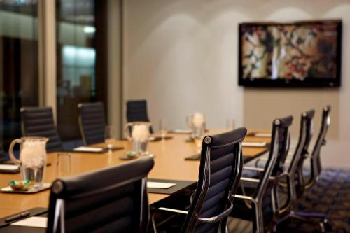 a conference room with a long table and chairs at Marriott Montreal Airport In-Terminal Hotel in Dorval