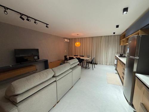 a living room with couches and a dining room table at Casa Aroeira Milagres in São Miguel dos Milagres