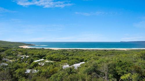 an aerial view of a beach and the ocean at 'The Yurt' by HolidayCo in Hardys Bay