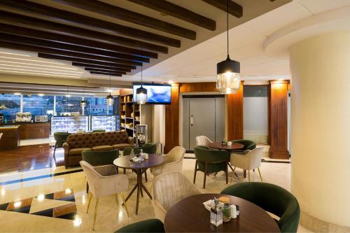 a restaurant with tables and chairs and a couch at JW Marriott Quito in Quito