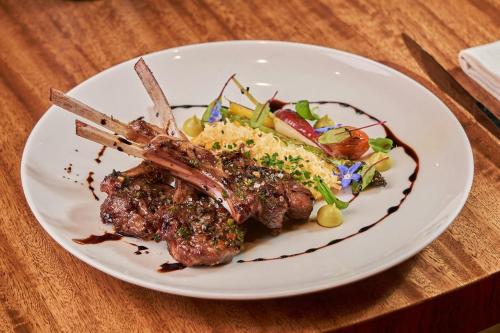 a plate of food with meat and vegetables on a table at JW Marriott Quito in Quito
