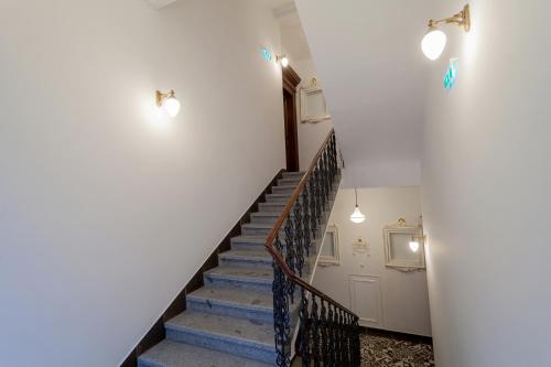 a staircase in a house with blue stairs and lights at VINOHRADSKY DUM Residence in Prague