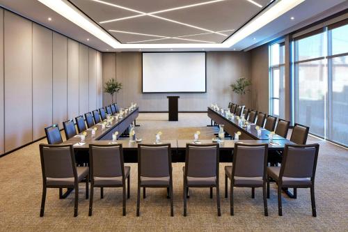 a conference room with a long table and chairs at SpringHill Suites by Marriott Los Angeles Downey in Downey