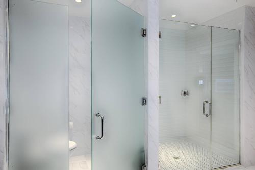 a shower with a glass door in a bathroom at Marriott Syracuse Downtown in Syracuse