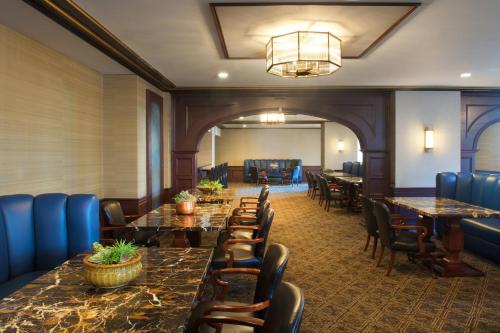 a row of tables and chairs in a restaurant at Marriott Syracuse Downtown in Syracuse