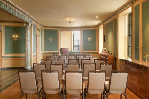 an empty room with chairs and a podium at Marriott Syracuse Downtown in Syracuse
