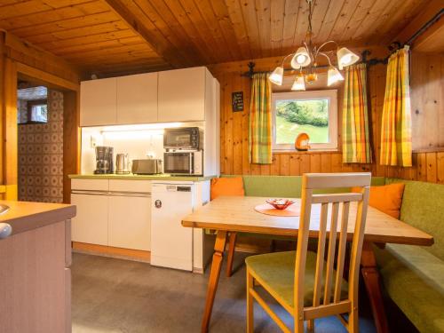 a kitchen and dining room with a table and chairs at Resinger in Hinterburg