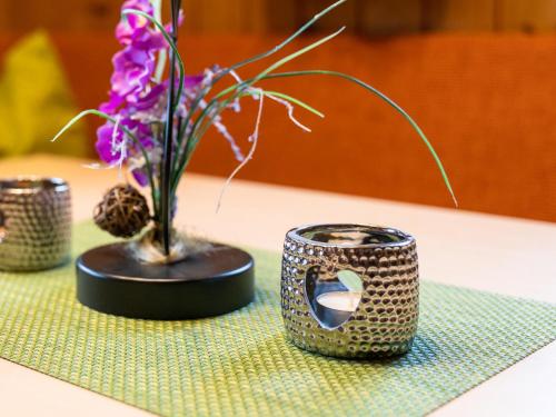 a table with a vase with flowers on it at Resinger in Hinterburg