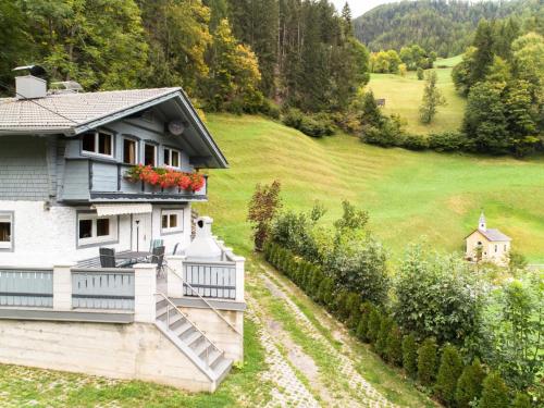 a house with a balcony with flowers on it at Resinger in Hinterburg