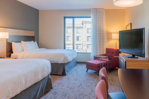 a hotel room with two beds and a flat screen tv at TownePlace Suites by Marriott Thousand Oaks Agoura Hills in Agoura Hills