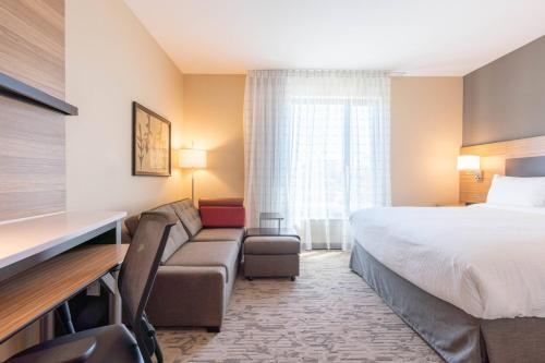 a hotel room with a bed and a couch at TownePlace Suites by Marriott Thousand Oaks Agoura Hills in Agoura Hills
