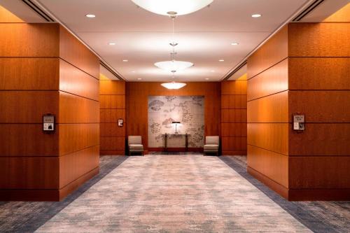 a hallway with wooden walls and a table in a room at The Ritz-Carlton, Boston in Boston
