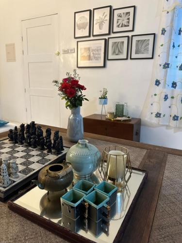 a table with a chessboard and a vase on it at Tubod Mar Terraza 3 bedrooms and basement up to 18 pax in Larapan