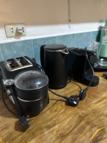a kitchen counter with two pots and a stove at Tubod Mar Terraza 3 bedrooms and basement up to 18 pax in Larapan