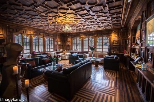a large room with couches and tables and windows at Hotel Boutique Cultura Manor by Café Cultura in Quito