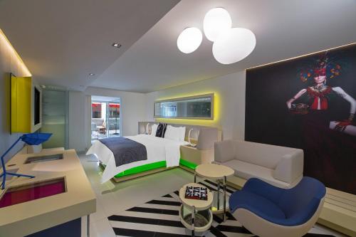 a bedroom with a king sized bed and a couch at W Mexico City in Mexico City