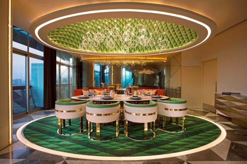 a dining room with a table and a chandelier at W Mexico City in Mexico City