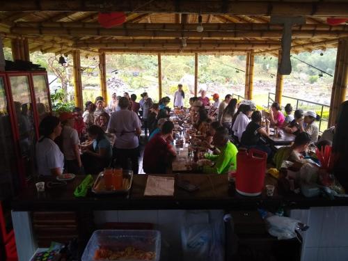 a group of people sitting at tables in a restaurant at Acualandia Fish in Sasaima