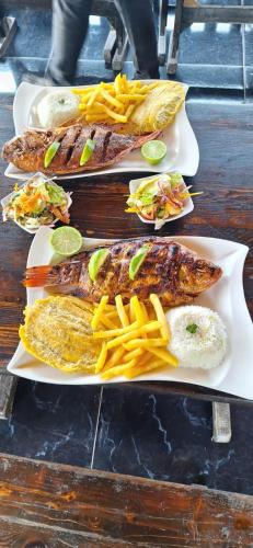 three plates of food with fish and french fries at Acualandia Fish in Sasaima