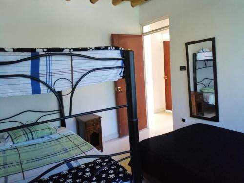 a bunk bed in a room with a mirror at Acualandia Fish in Sasaima