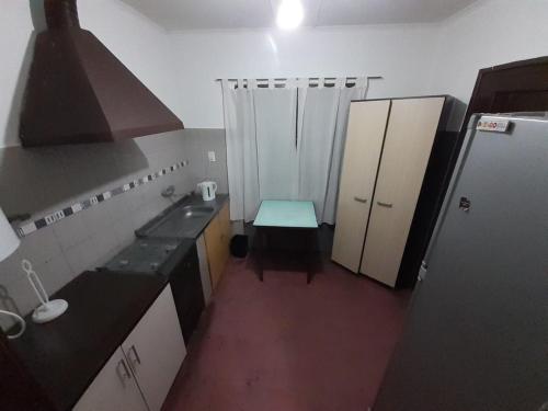 a small kitchen with a sink and a refrigerator at Alojamiento La Nihuilence in El Nihuil