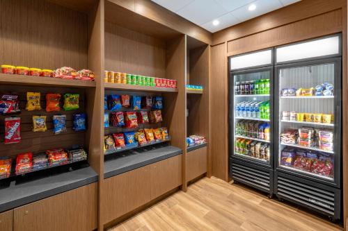 a grocery store aisle with food and drinks at Madison Marriott West in Middleton