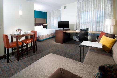 a hotel room with a bed and a desk at Residence Inn by Marriott Augusta in Augusta