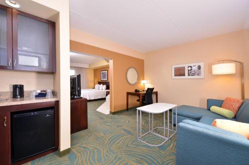 a hotel room with a couch and a table at SpringHill Suites Arundel Mills BWI Airport in Hanover