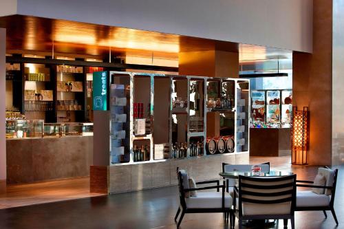 a dining room with a table and chairs in a restaurant at The Westin Hyderabad Mindspace in Hyderabad