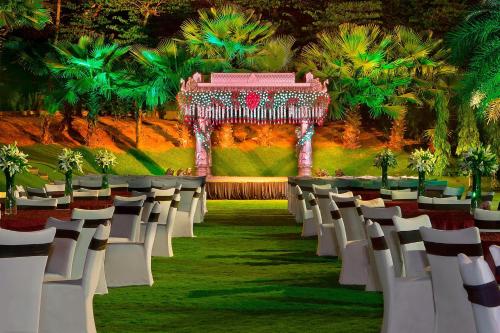 an aisle with white chairs and a gazebo at The Westin Hyderabad Mindspace in Hyderabad