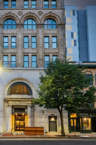 a large building with a tree in front of it at SpringHill Suites by Marriott Baltimore Downtown Convention Center Area in Baltimore