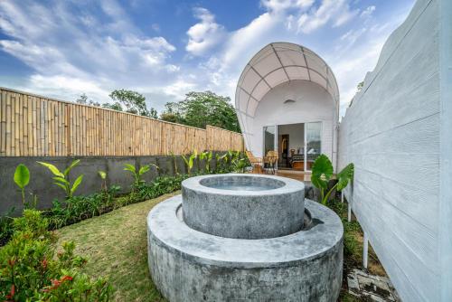 a garden with a stone circle in the middle at The Dewi Kintamani Luxury Glamping and Natural Hotspring in Kintamani