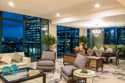 a living room with a view of the city at night at Sheraton Maria Isabel Mexico City Reforma in Mexico City