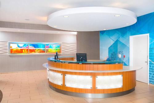 a lobby with a reception desk in a office building at SpringHill Suites By Marriott Columbia Fort Meade Area in Columbia