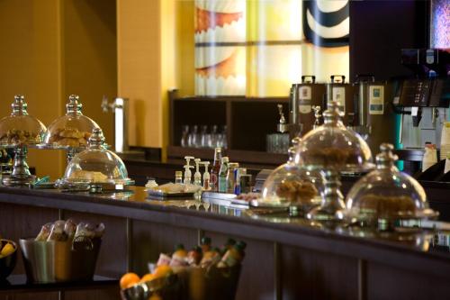 a bar with glass domes on top of a counter at Falls Church Marriott Fairview Park in Falls Church