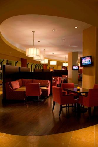 a lobby with a couch and tables and chairs at Falls Church Marriott Fairview Park in Falls Church