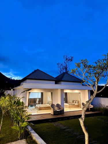 a house with a porch with two couches at Volcano Side Kintamani Bali in Kintamani