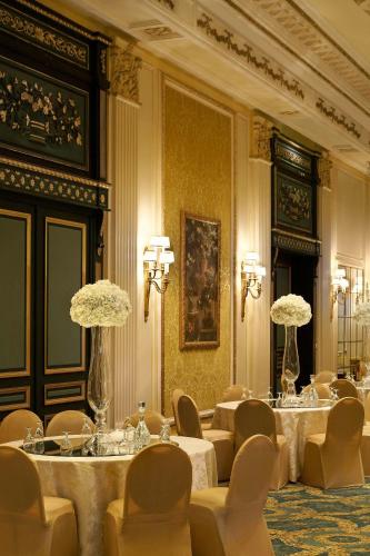 a meeting room with tables and chairs and flowers at Le Meridien Al Khobar in Al Khobar